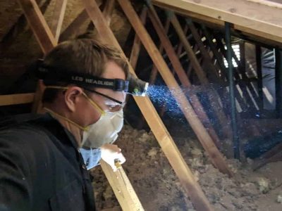 handyman performs residential property maintenance in attic of sacramento home